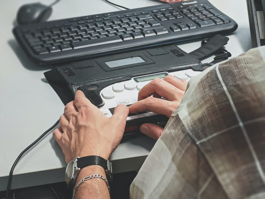 A person using an alternative keyboard as a form of digital accessibility. 